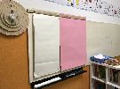 Angolo polivalente costruito dalle insegnanti: atelier grafico e lavagna a fogli 